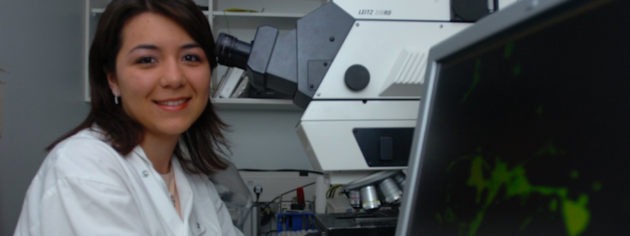 Female scientist by a microscope