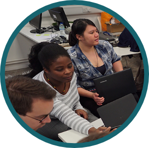 A photo of a group of people are working together on a project, they have their laptops in front of them