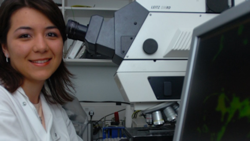 Female scientist by a microscope