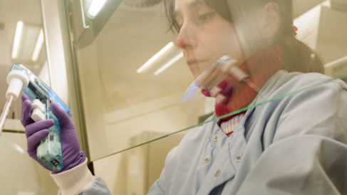 Female scientist in a lab doing an experiment