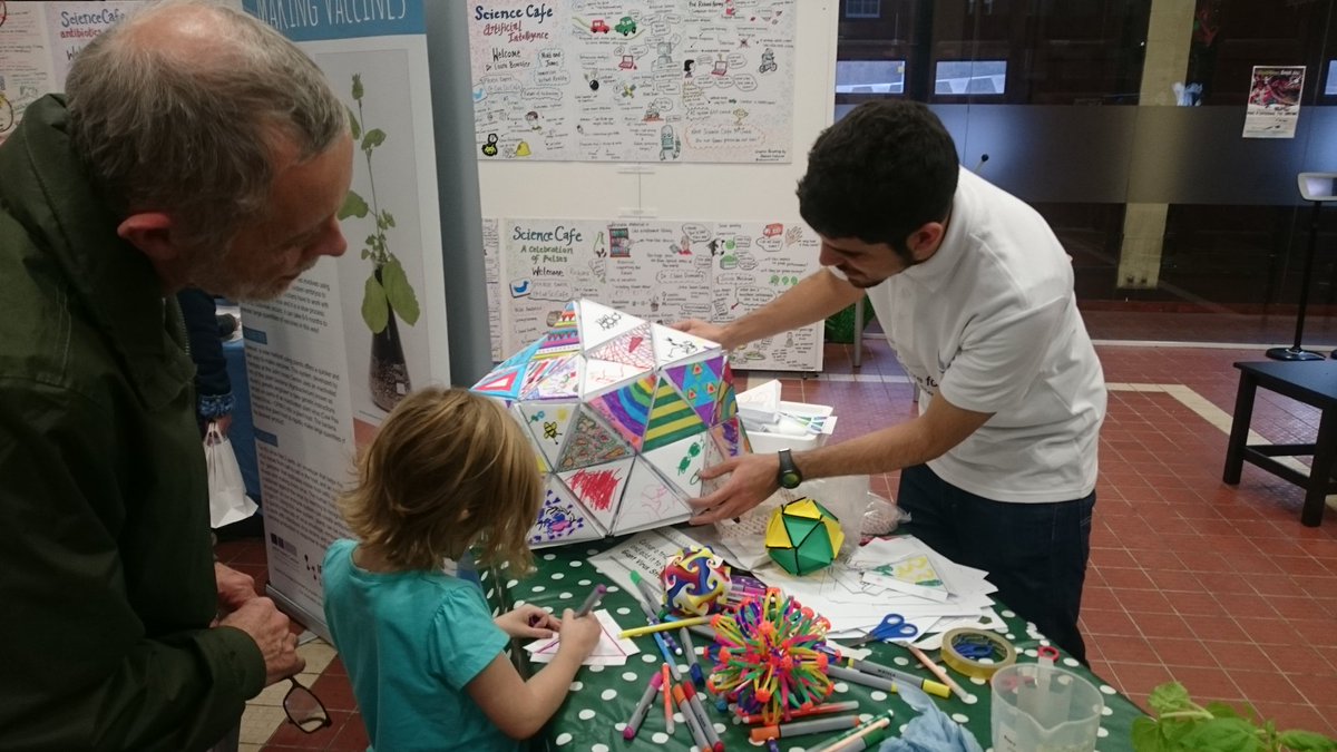 Pictured in the middle, is a prototype constructed by the VRICKs team, created using the laser cutter. The project was presented at the Science Festival in Norwich along with Roger’s PhD project on viral structures (pictured in the left). Photo Credit: Ro